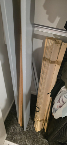 Wooden boards and panels stacked vertically and horizontally.