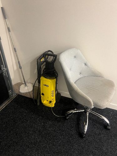 Swivel chair, yellow vacuum cleaner, mop.