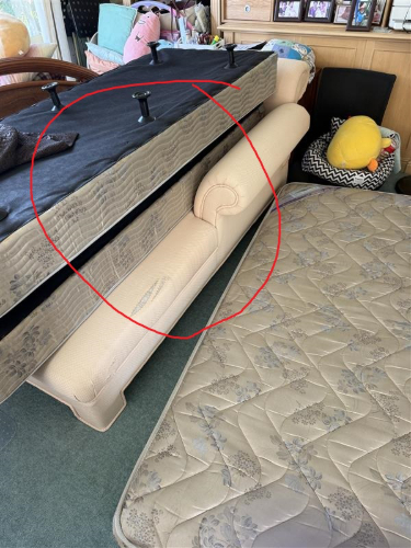 Black mattress, cream-colored couch with curved arm, and beige quilted mattress.