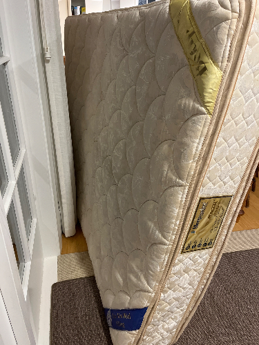 Mattress with decorative quilted design and labels.