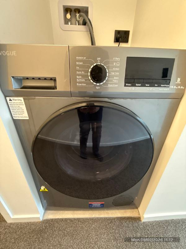 Washing machine with digital controls and front-loading door.
