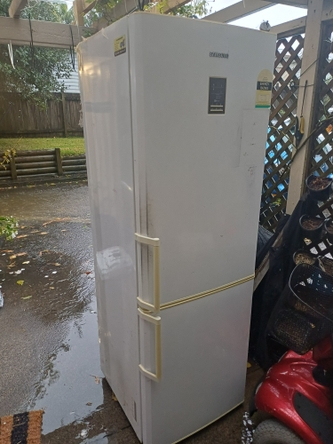 White refrigerator with yellow handles.