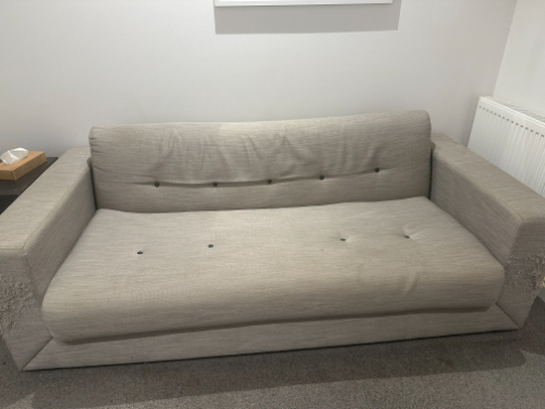 Gray fabric sofa with buttons.