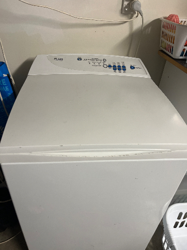 White top-loading washing machine with control panel.