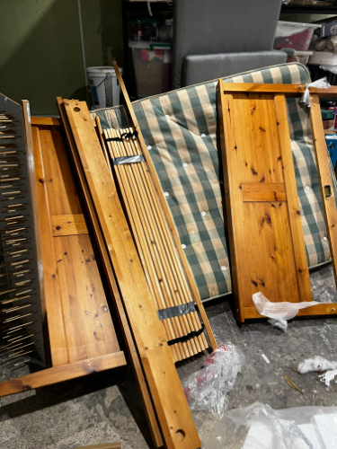 Wooden furniture pieces, striped green and beige fabric, plastic wrap.