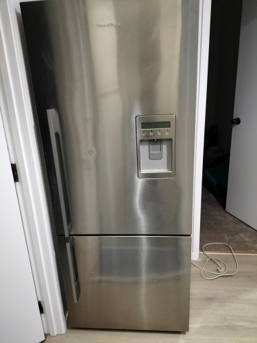 Stainless steel refrigerator with water and ice dispenser.