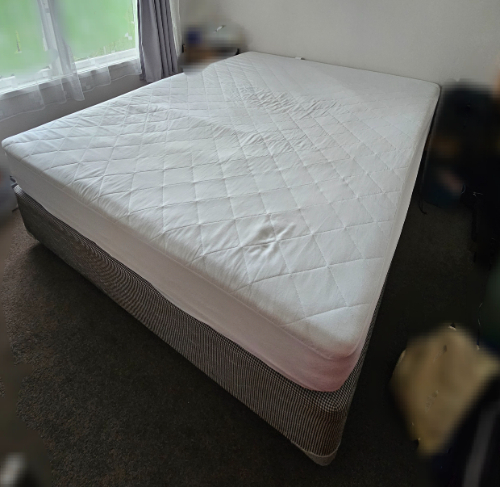 Queen-sized mattress with a removable cover.