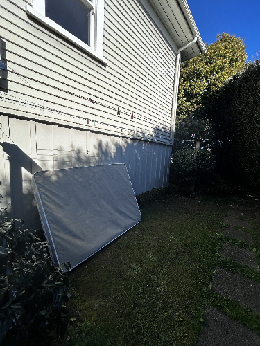 Mattress propped against a wall.