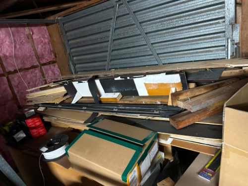 Wooden planks, cardboard boxes, electrical cable reel.