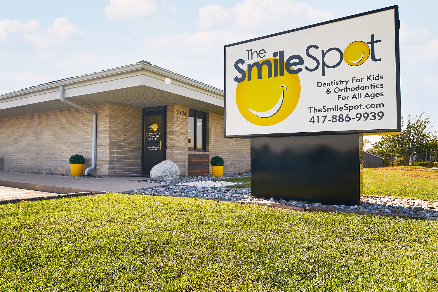 A smile spot sign in front of a building.