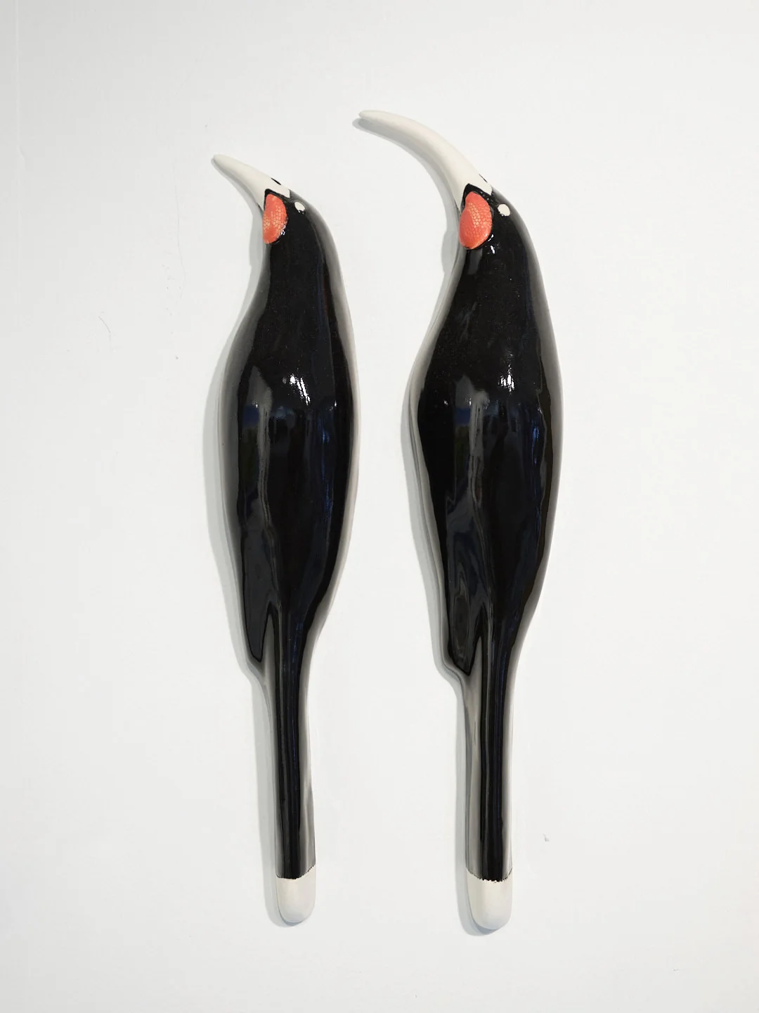 pair of glazed ceramic wall hung Huia birds, (approx. 330 x 60 mm each)