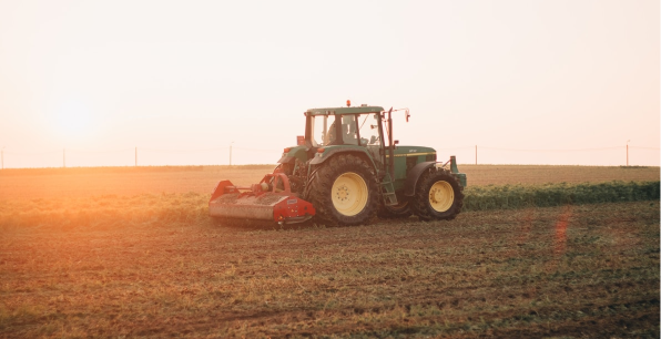 A tractor on a barren field