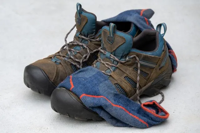 Hiking shoes and socks displayed together on a light surface.