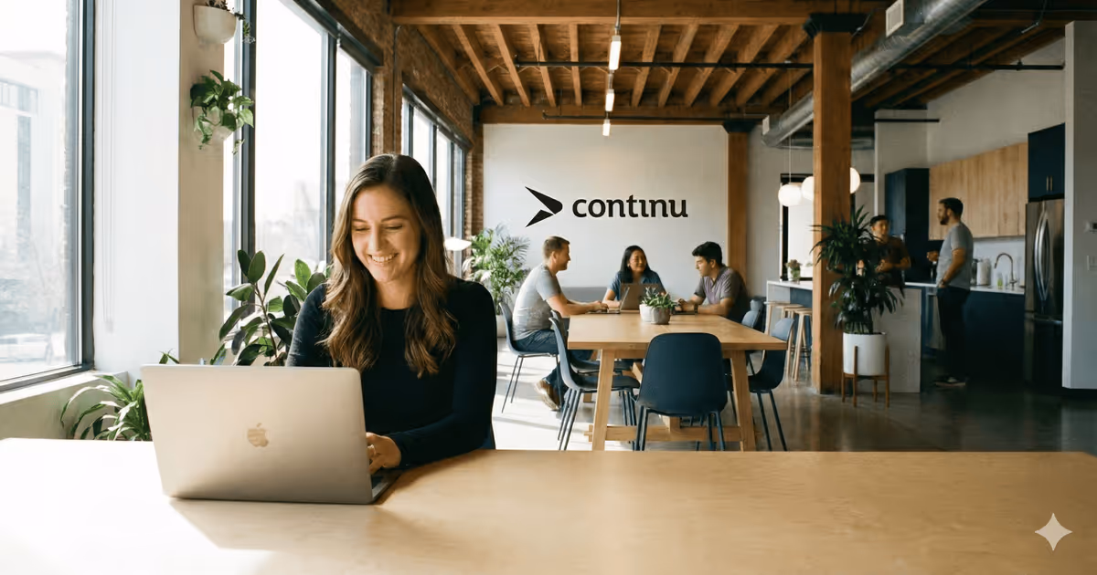 A SaaS employee in a modern office using an AI LMS on their laptop.