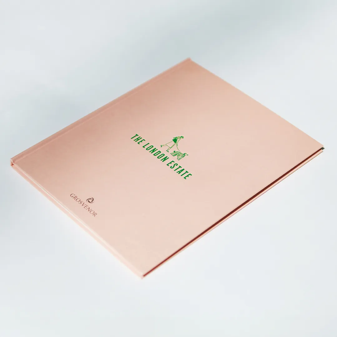 A sleek, pastel-pink book titled "The London Estate" with the Grosvenor logo, displayed against a minimalist light background.