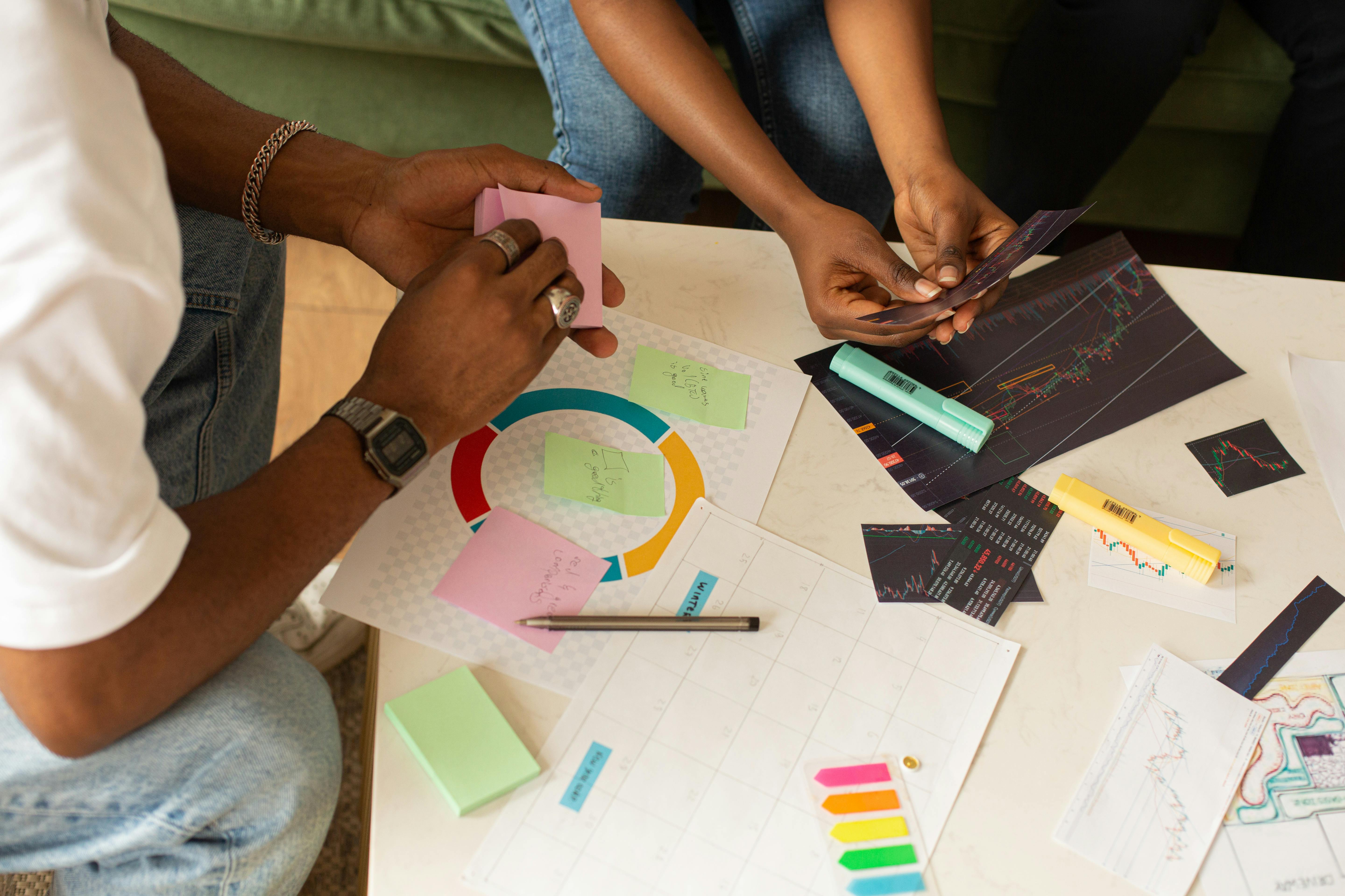 Team collaborates using charts and sticky notes for planning and analysis.