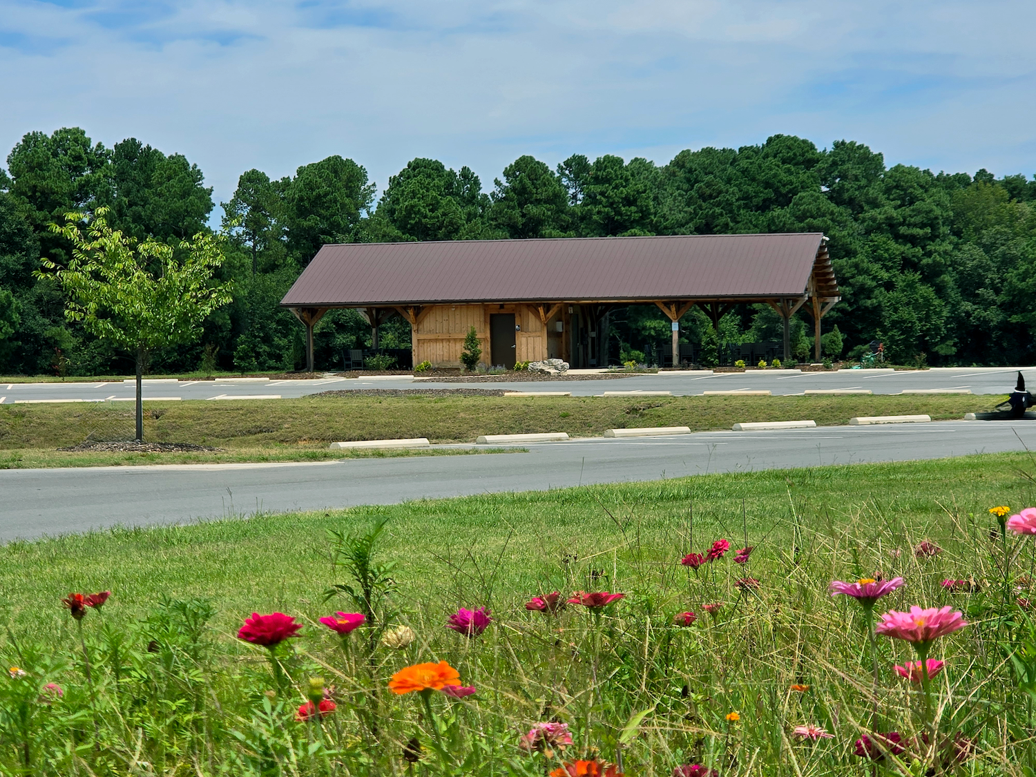 Open-air pavilion and restroom facility at Hardee Lane Park in Whispering Pines, North Carolina, designed by Longitude Planning Group as part of the park’s recreation and amenity master plan.