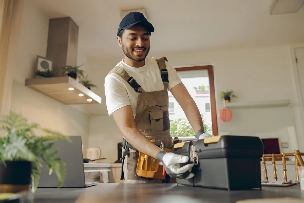 man opening tool box inside kitchen