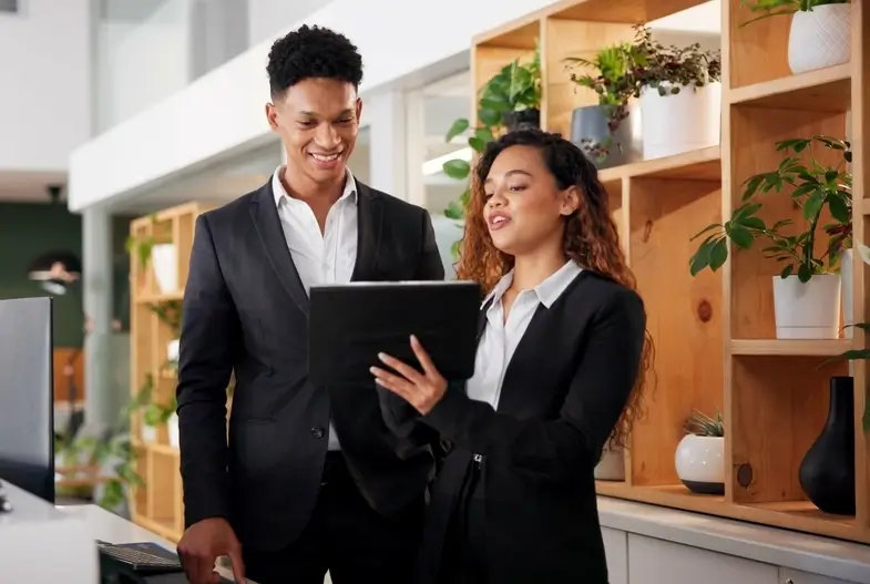 male and female receptionist looking at document