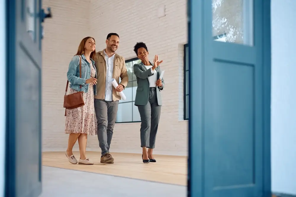 real estate agent showing a couple around the house