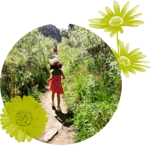 child hiking on sunny trail during summer