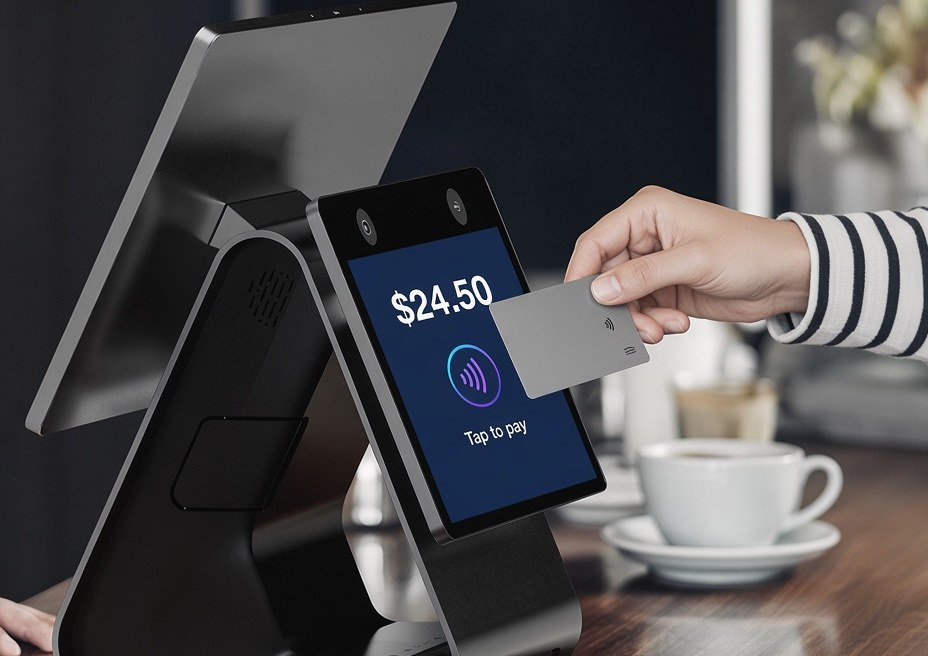 Customer tapping a card on the Payflo dual-screen terminal