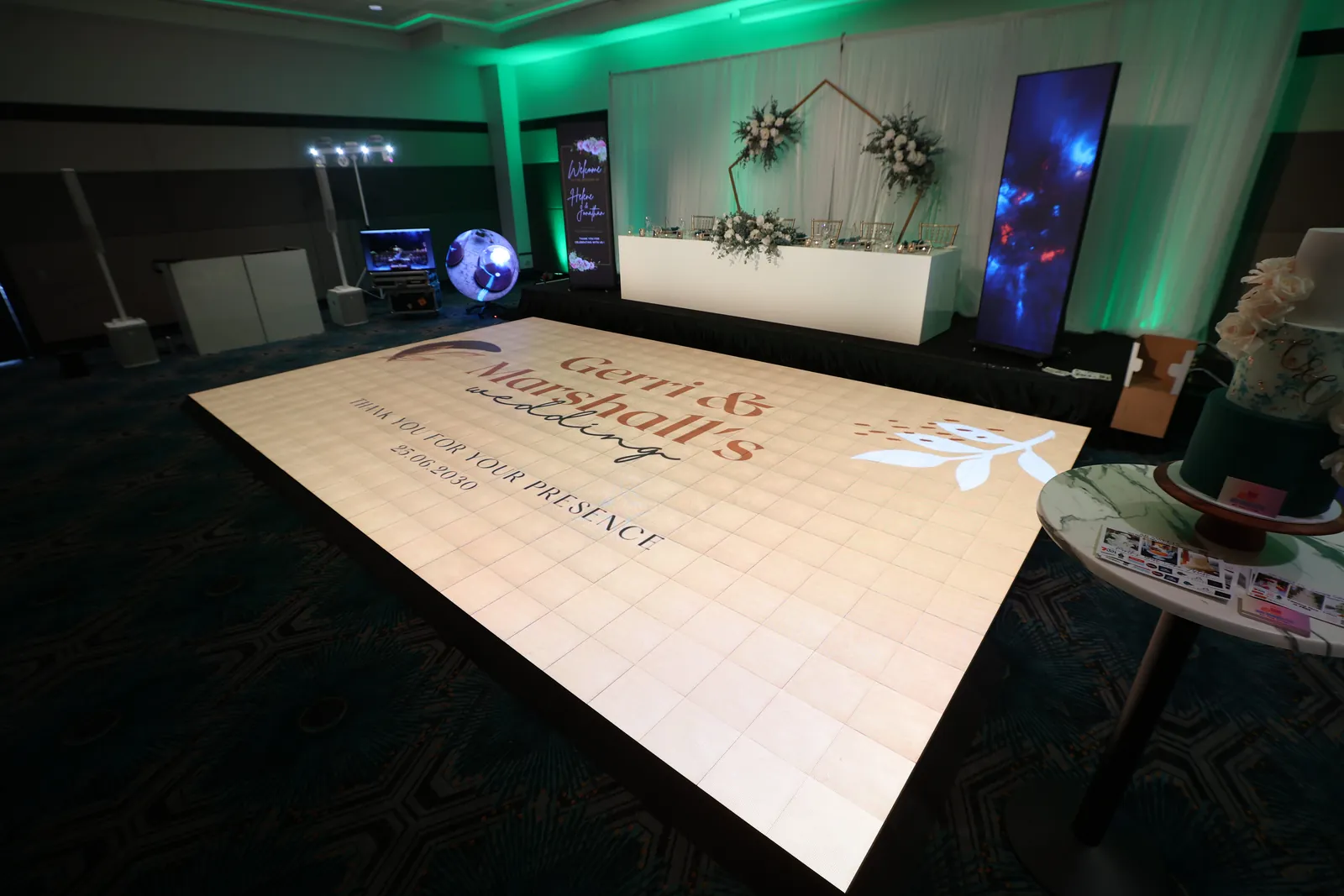 Wide view of the Stomp interactive LED dance floor at Rendezvous Hotel Scarborough showing Gerri & Marshall's wedding message beside the bridal table