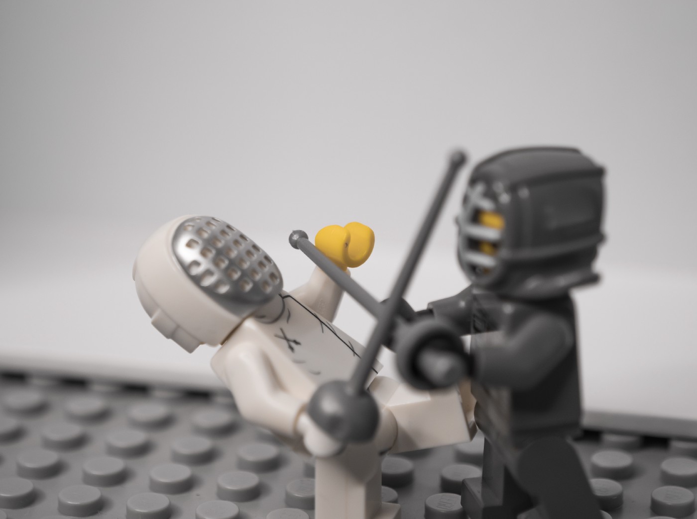 Two lego figures fighting with each other.