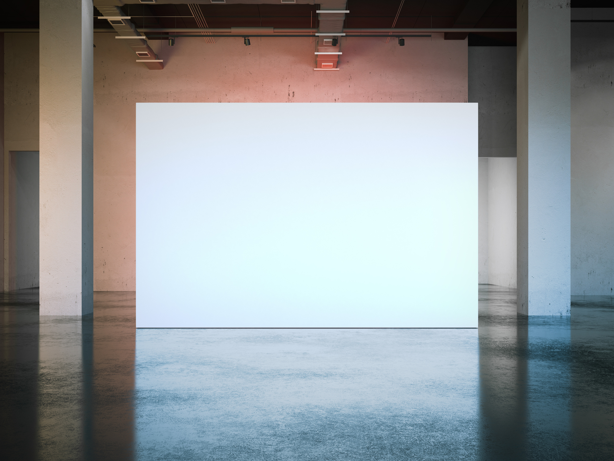 Empty white rectangular billboard in an industrial warehouse with concrete columns and reflective floor.
