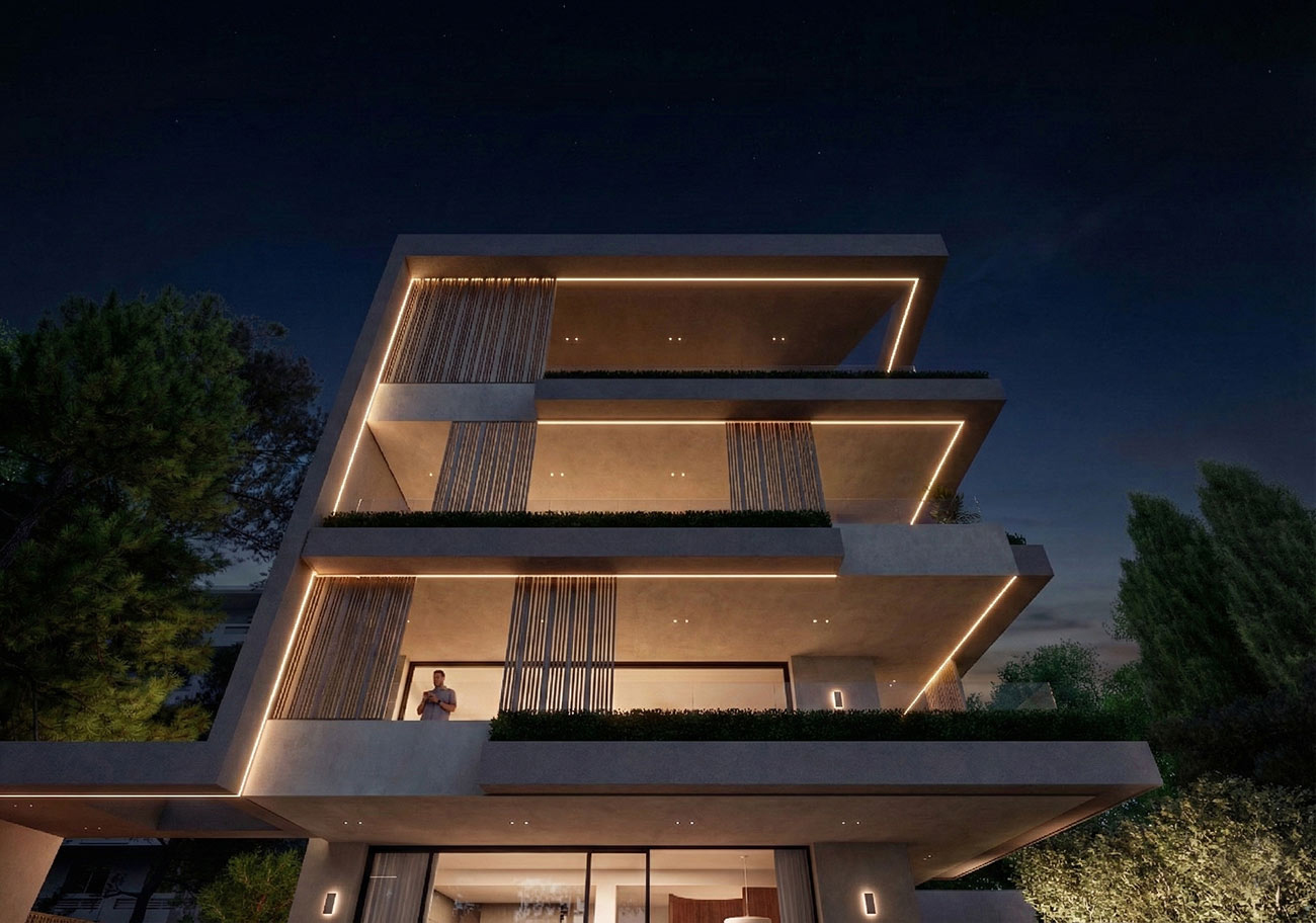 Contemporary multi-level luxury residence in Voula with warm façade lighting during sunset