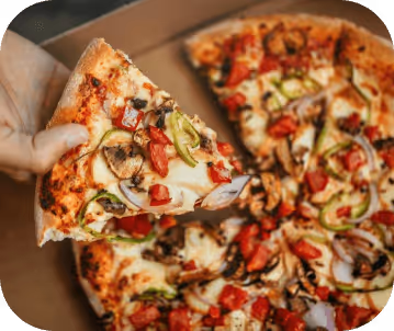 close up of a hand lifting a ultimate veggie/meat pizza