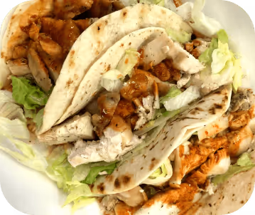 close up of three soft shell pork tacos