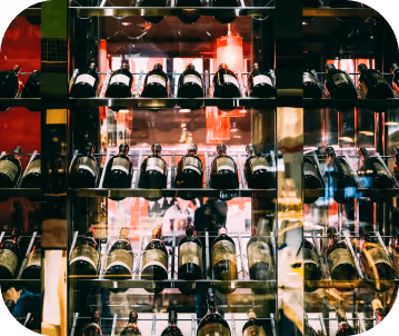 full shot of a liquor shelve displaying varieties of red wine.