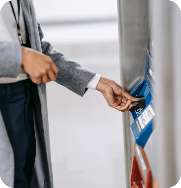 young female paying for gas with a card to pump gas.