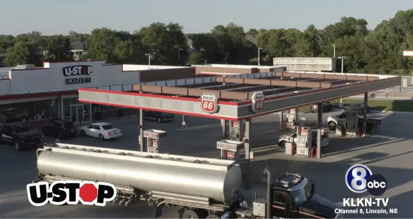 Philips 66 gas station and U-Stop market in a tree-lined area, featuring multiple fuel pumps and a tanker truck. KLKN-TV ABC logo in the corner.