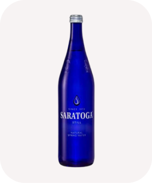 Blue glass bottle of Saratoga Natural Spring Water with silver cap, featuring sleek design and white text. Elegant and refreshing vibe.