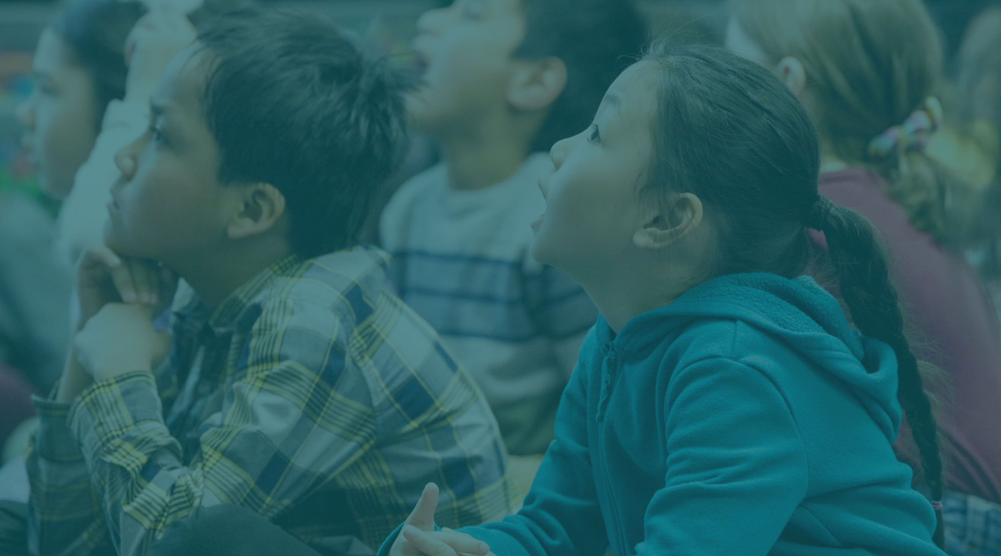 Tree roots on a forest floor in Juneau with a totem from the Tlingit Tribe in the background.
