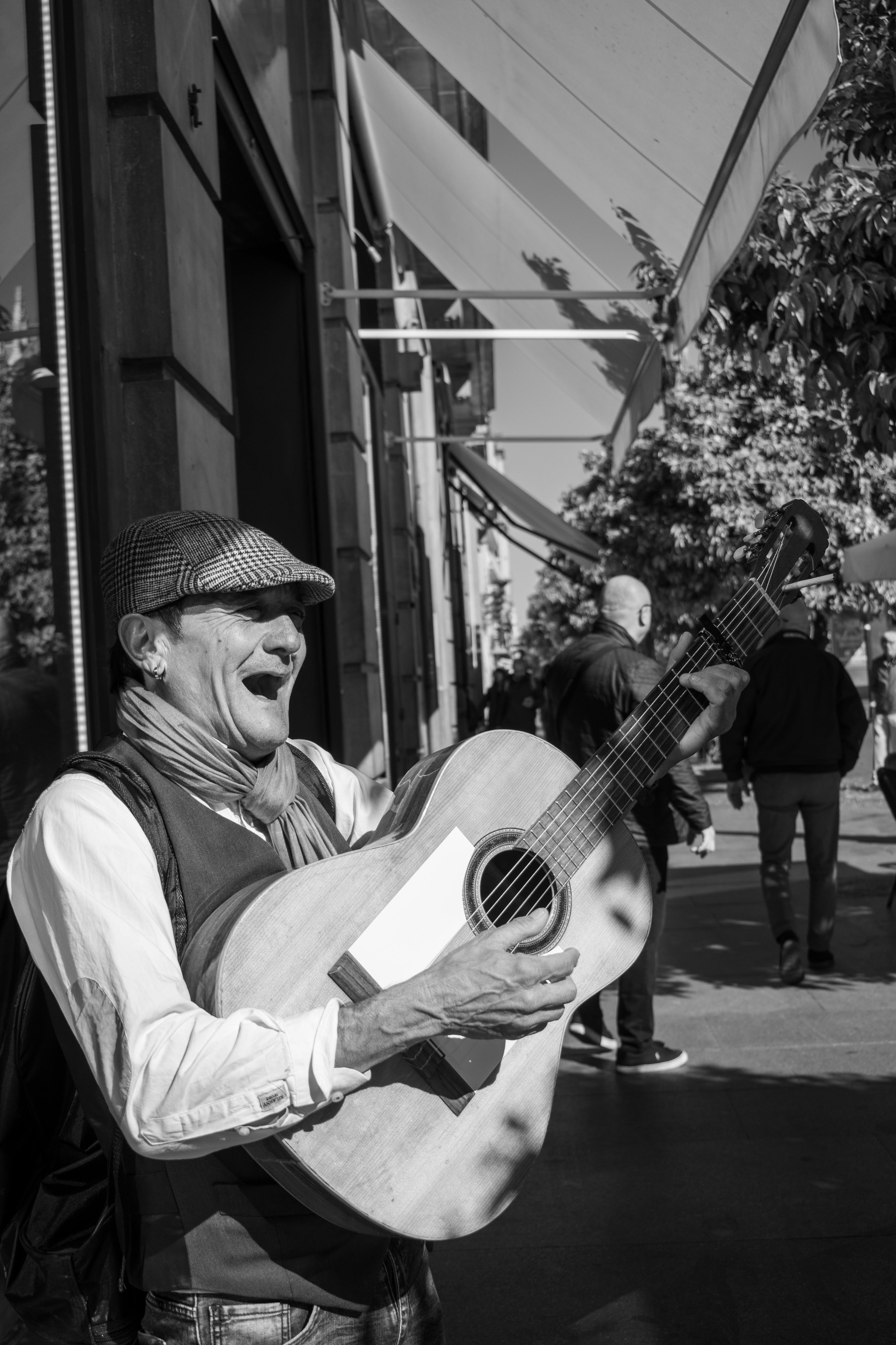 Elderly man playing guitar outside as a form of therapy