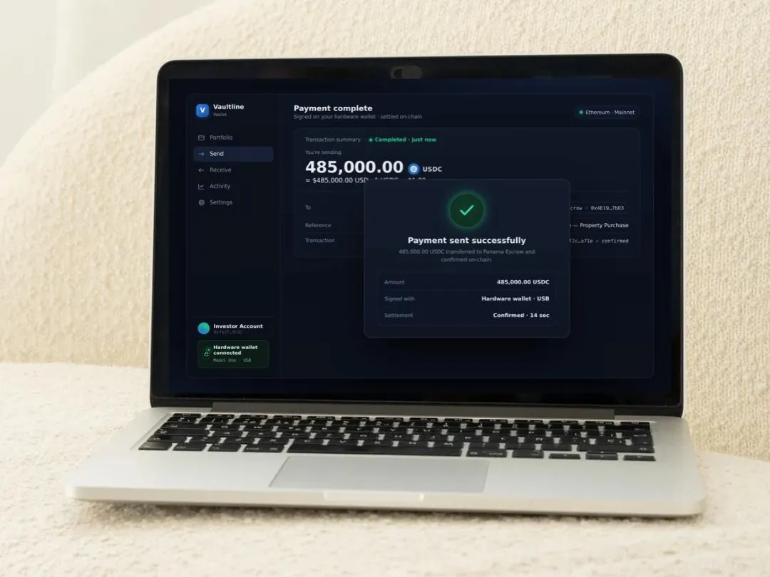 Laptop showing a completed cryptocurrency payment for a property purchase