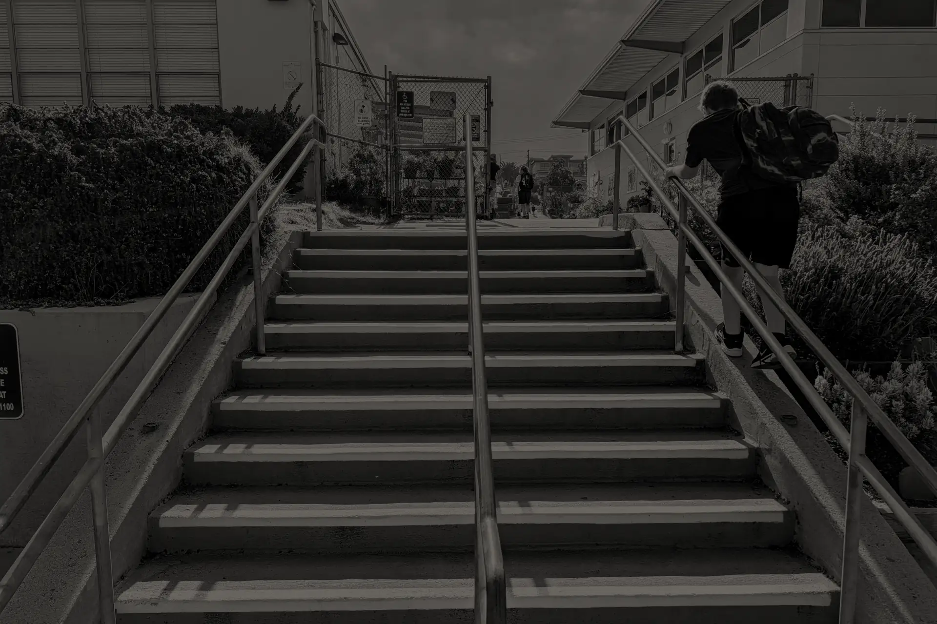 Child with a backpack climbing stairs up to elementary school in San Diego, California.
