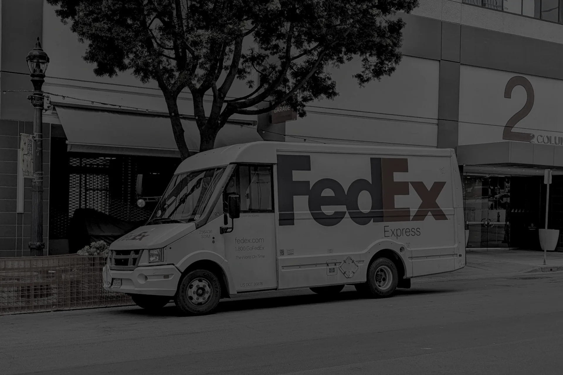 FedEx Express delivery truck on a downtown San Diego street at night.
