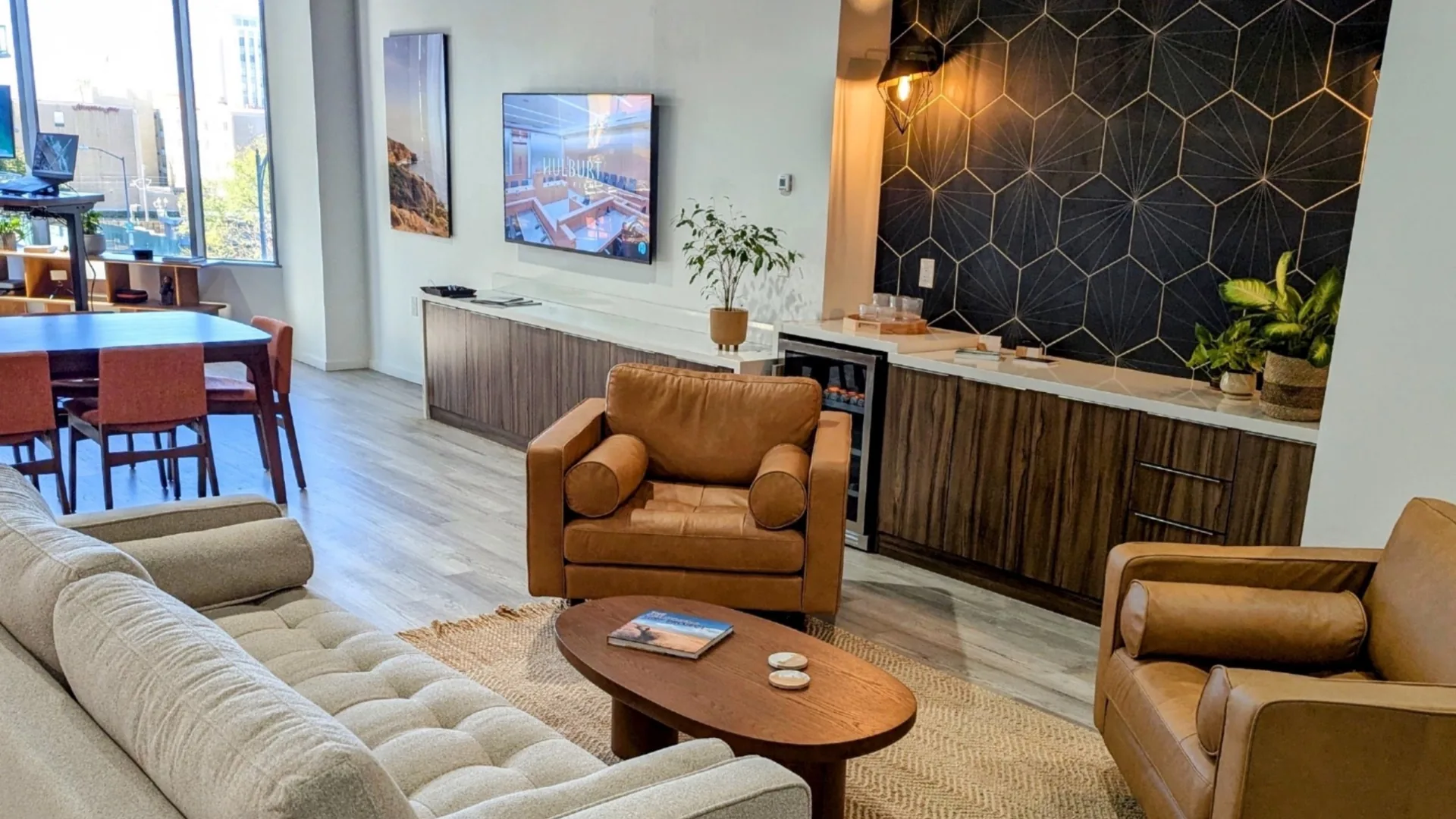 Client lounge at Hulburt Law Firm's downtown San Diego office, with leather armchairs, sofa, and conference table.