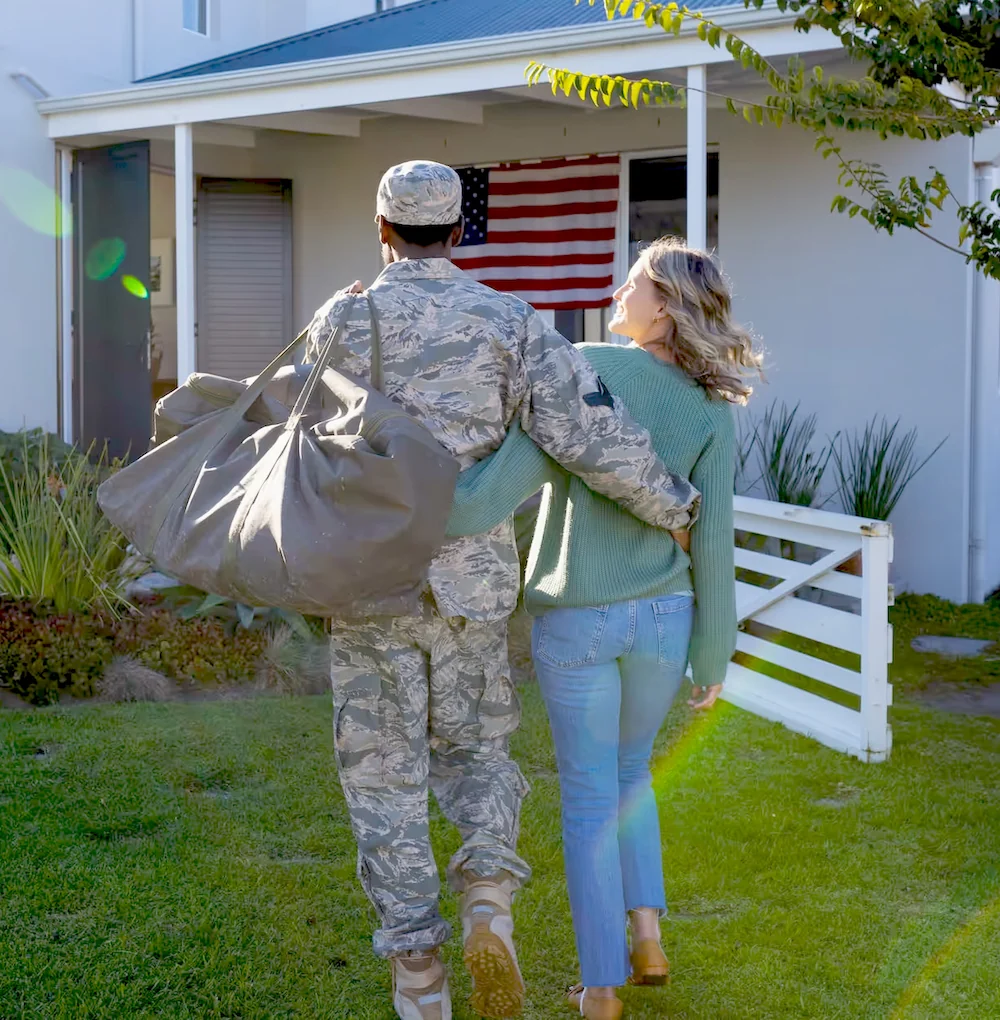 veteran and significant other walking into their new home purchased with a va loan