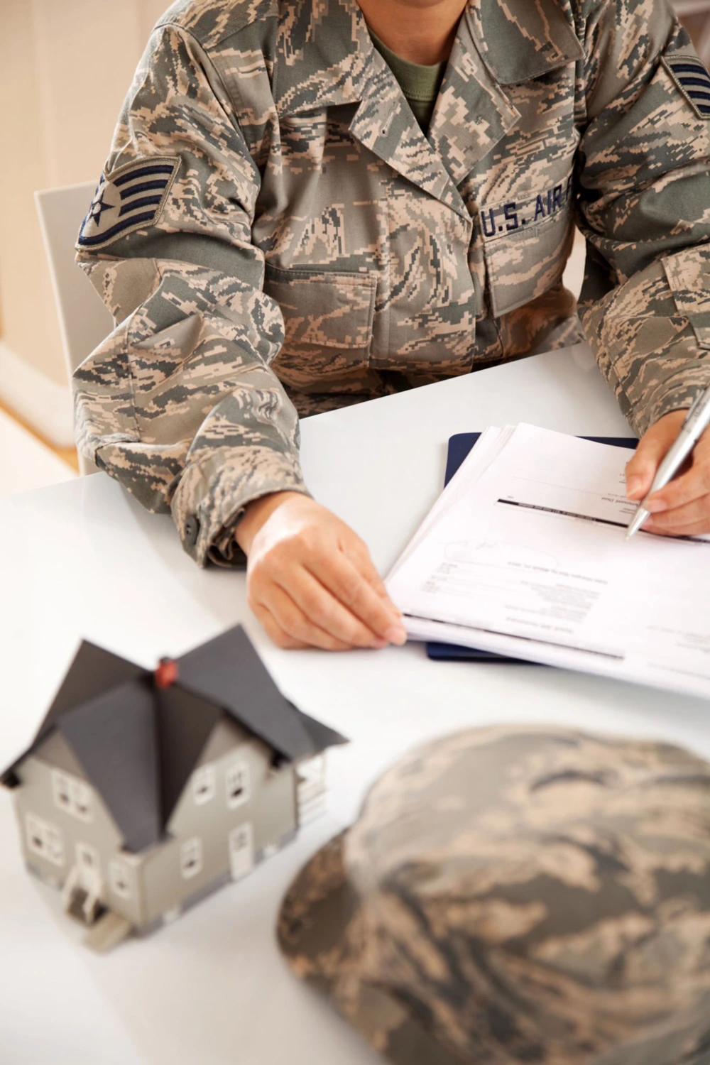 US Air Force Officer signing purchasing house with VA Loan