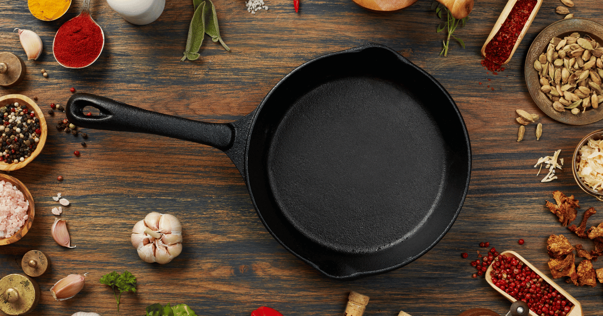 A cooking pan surrounded by ingredients