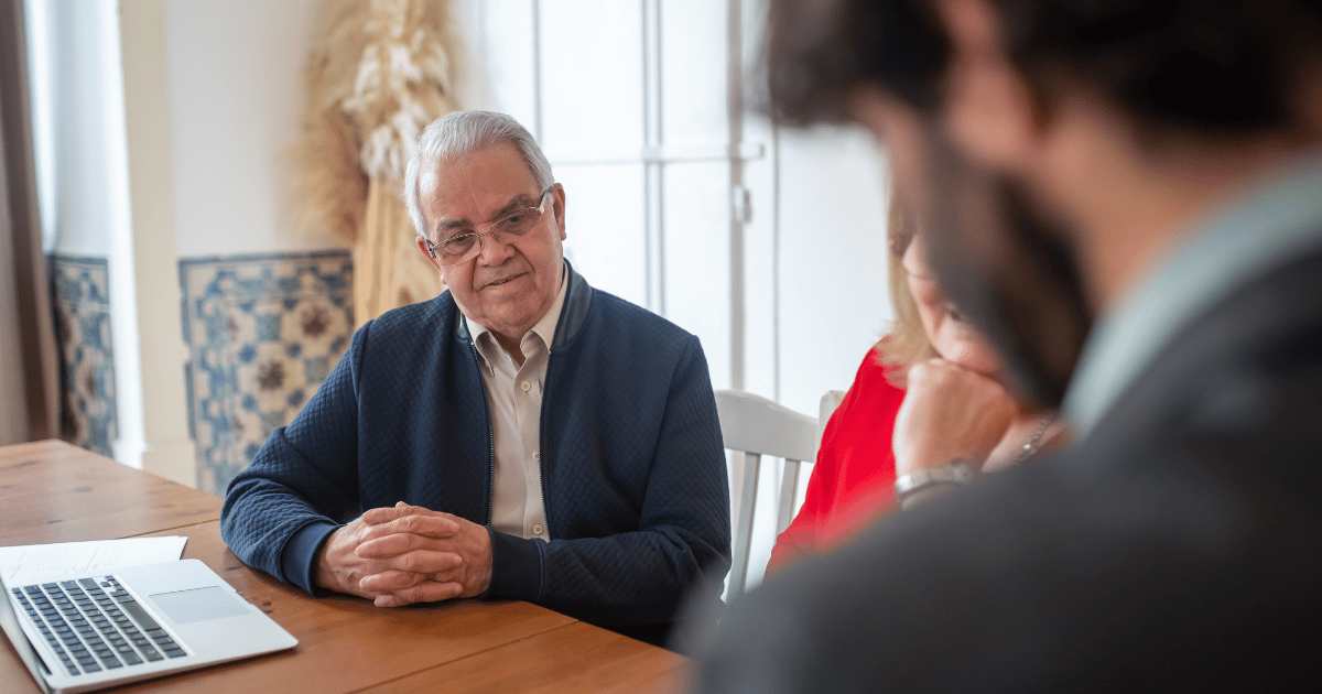 An adviser in a meeting with older clients