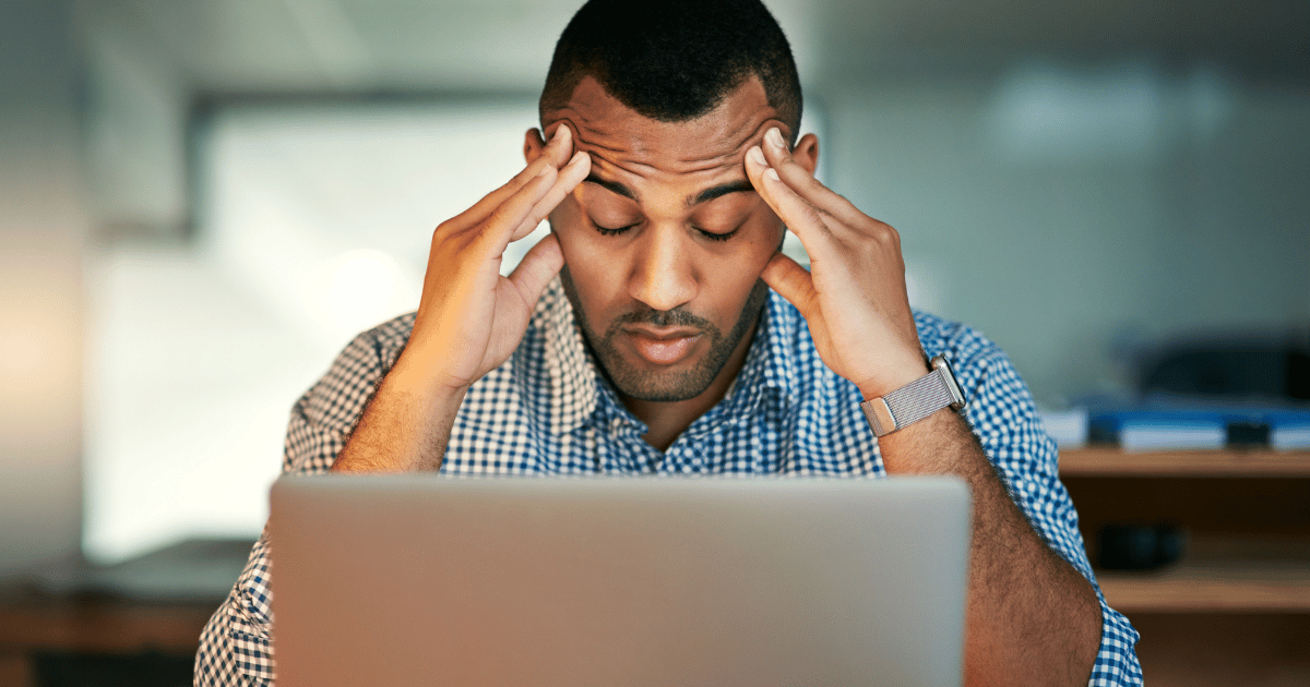 A man holds his head in his hands