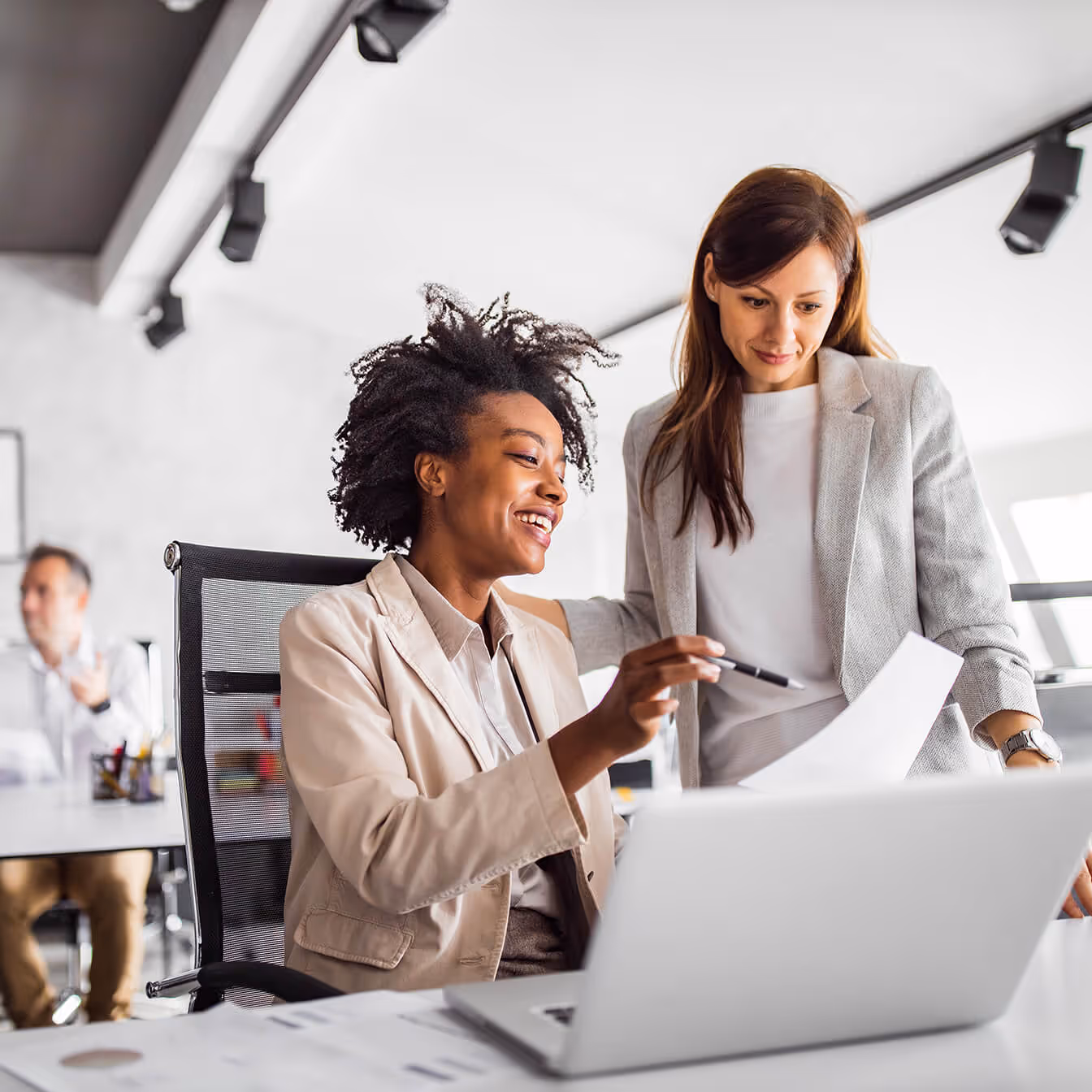 two people at a desk talking