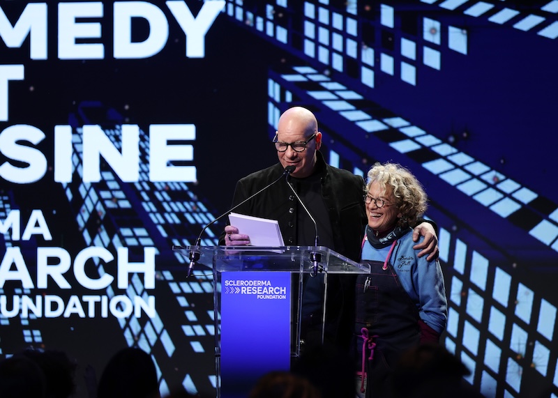 NEW YORK, Nov. 12, 2025 — (L-R) Jeff Ross and Susan Feniger speak onstage during the Scleroderma Research Foundation’s Cool Comedy • Hot Cuisine event at the Edison Ballroom in New York City. (Photo by Kevin Mazur/Getty Images for the Scleroderma Research Foundation) / Source: Scleroderma Research Foundation (SRF) (EZ Newswire)