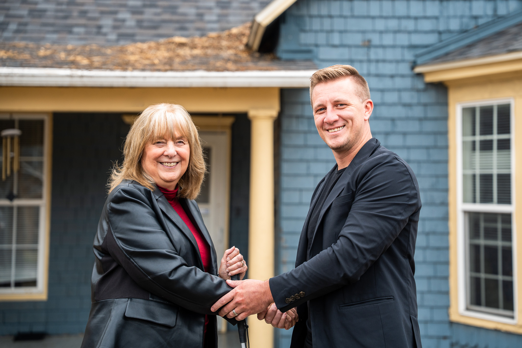 Midwest Roofing CEO Madison Plemmons and Love Columbia Executive Director Jane Williams shaking hands. / Source: Midwest Roofing (EZ Newswire)